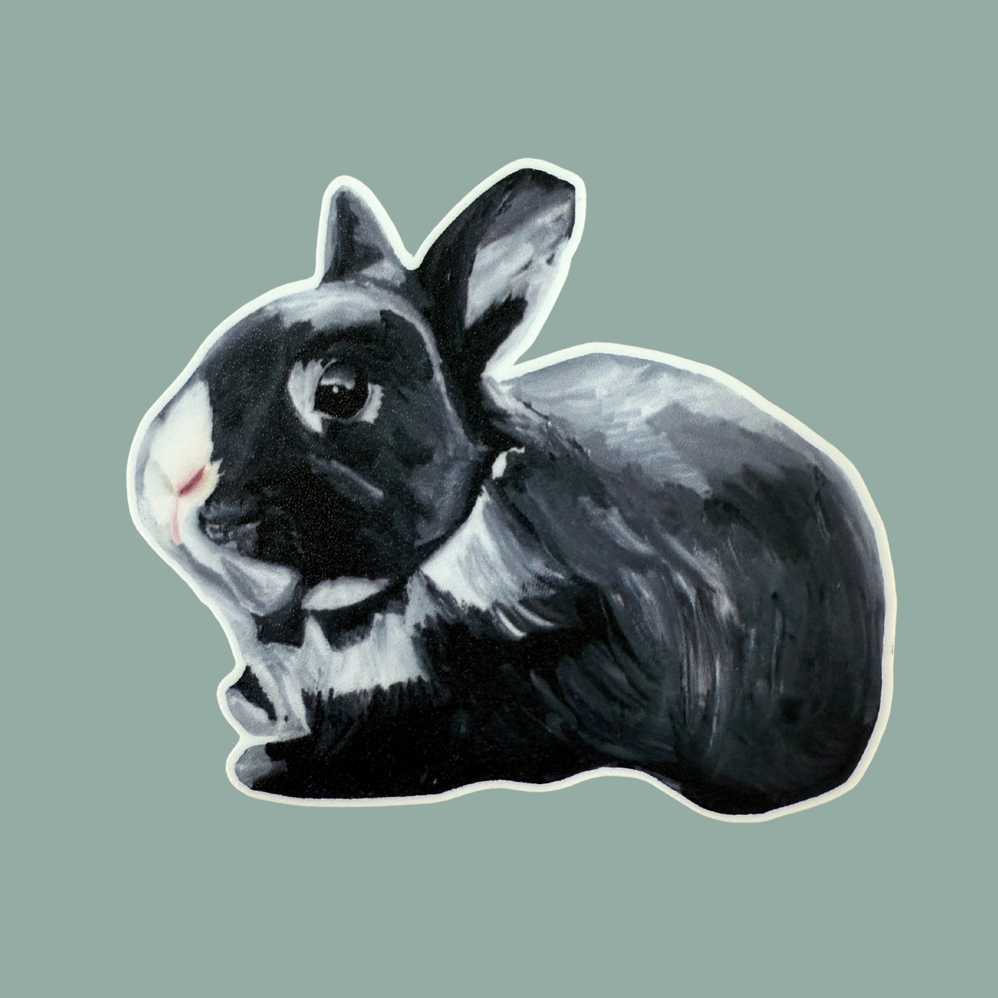 Black rabbit sticker on a teal background