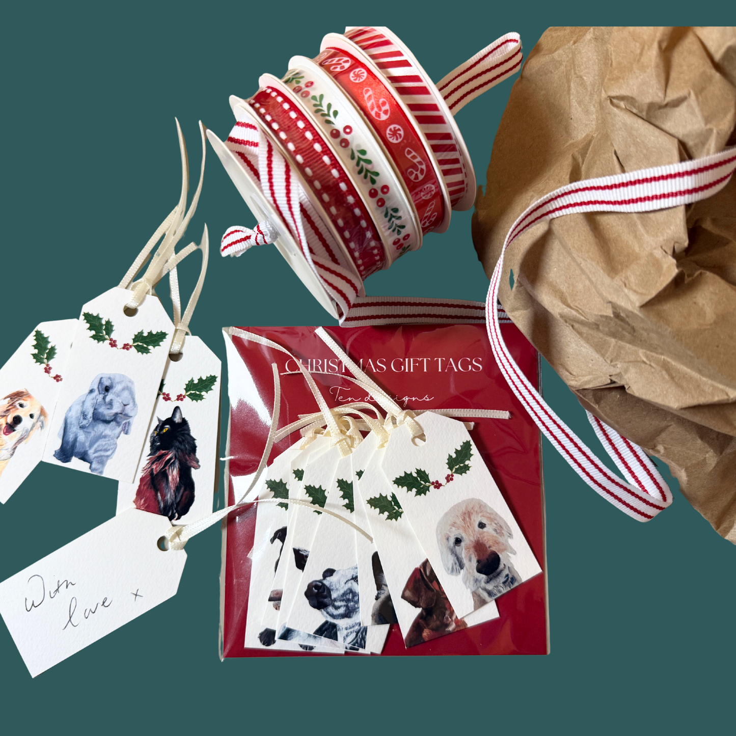 Pack of 10 gift tags with animal designs on white card stock. The pack is surrounded by assorted red ribbons, loose gift tags, & brown paper